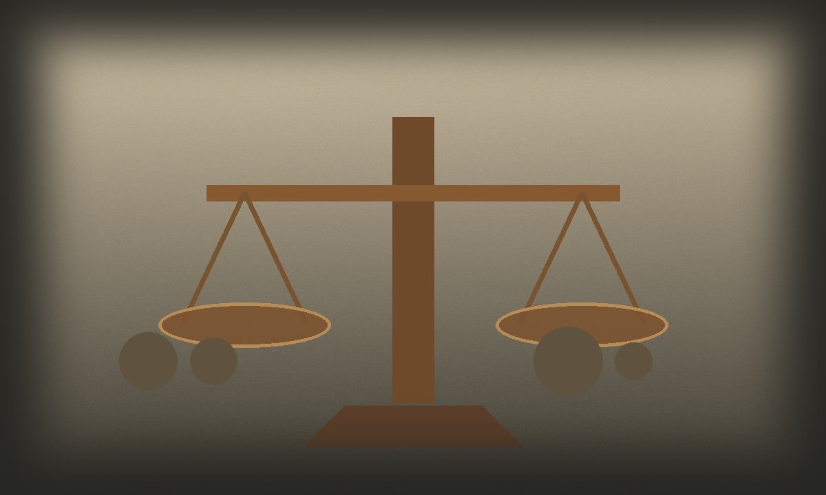 A simple bronze balance with small plain weights on linen
